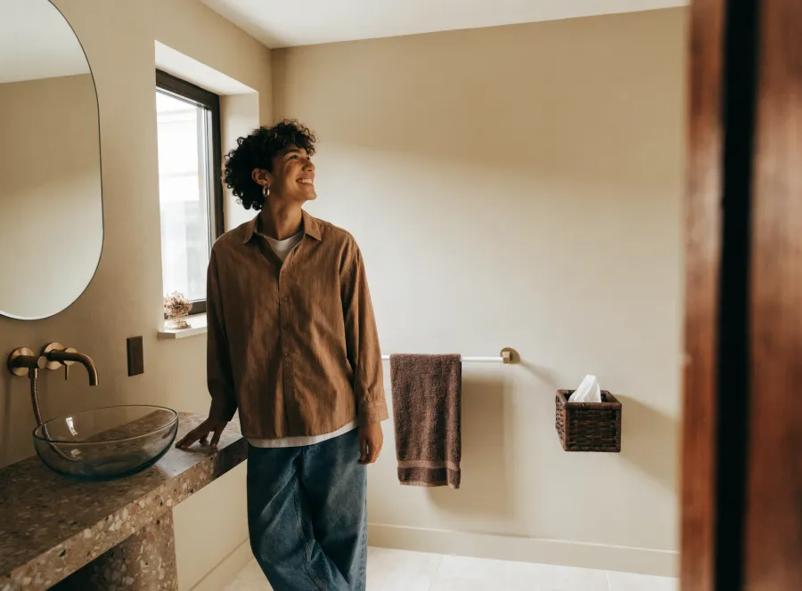 Happy homeowner in a newly remodeled bathroom